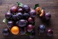 Ripe juicy plums on a wooden background. Royalty Free Stock Photo