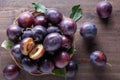 Ripe juicy plums on a wooden background. Royalty Free Stock Photo