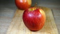 Ripe juicy red apple on a wooden cutting board Royalty Free Stock Photo