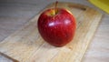 Ripe juicy red apple on a wooden cutting board Royalty Free Stock Photo