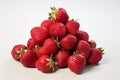 Ripe and juicy red strawberries with green leaves isolated on a clean white background