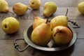 Ripe, juicy Rocha pears on an antique tray.