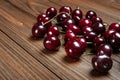 Ripe juicy sweet cherries on a wooden background. Lots of wet fresh cherries with water drops Royalty Free Stock Photo