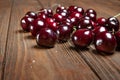 Ripe juicy wet sweet cherries on a wooden background. Lots of wet fresh cherries with water drops Royalty Free Stock Photo