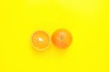 Ripe Juicy Whole and Halved Orange on Solid Yellow Background. Vitamins Healthy Diet Summer Detox Vegan Tropical Fruits