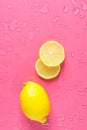 Ripe Juicy Whole and Sliced Lemon on Fuchsia Pink Background with Water Drops. Vitamins Healthy Diet Summer Detox Vegan Superfoods Royalty Free Stock Photo