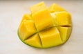 Ripe juicy yellow exotic mango cut into cubes on wooden background. Tropical delicacy full of vitamins for a healthy Royalty Free Stock Photo