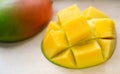 Ripe juicy yellow exotic mango cut into cubes on wooden background. Tropical delicacy full of vitamins for a healthy Royalty Free Stock Photo