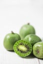 Ripe kiwi berries on a white table