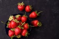 Ripe large strawberries in a blue cup on a dark concrete background. View from above Royalty Free Stock Photo