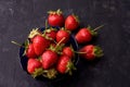 Ripe large strawberries in a blue cup on a dark concrete background. View from above Royalty Free Stock Photo