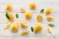 Ripe lemons and lemon leaves on wooden background. Top view.