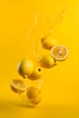 Ripe lemons with splashes of drops of water or juice on a yellow background, Generative AI