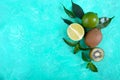 Ripe lime and kiwi fruit. Whole and cut fruits and mint leaves on a bright background. Royalty Free Stock Photo