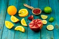 Ripe lime, orange, pomegranate fruit on wooden vintage background. Royalty Free Stock Photo