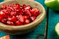 Ripe lime, pomegranate fruit on wooden vintage background. Healthy vegetarian food. Royalty Free Stock Photo