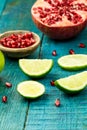 Ripe lime, pomegranate fruit on wooden vintage background. Healthy vegetarian food. Royalty Free Stock Photo