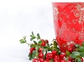 Ripe lingonberries and red cup with ornament