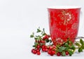 Ripe lingonberries and red cup with ornament