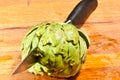 Ripe, local, freshly artichoke, being cut in half