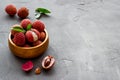 Ripe lychee. Exotic asian fruits in bowl on grey desk copy space Royalty Free Stock Photo