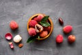 Ripe lychee. Exotic asian fruits in bowl on greydesk top-down copy space Royalty Free Stock Photo