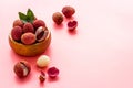 Ripe lychee. Exotic asian fruits in bowl on pink desk copy space Royalty Free Stock Photo