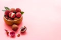 Ripe lychee. Exotic asian fruits in bowl on pink desk copy space Royalty Free Stock Photo