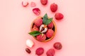 Ripe lychee. Exotic asian fruits in bowl on pink desk top-down copy space Royalty Free Stock Photo