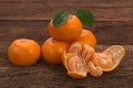 Ripe Mandarin fruit with leaves and one peeled open Royalty Free Stock Photo