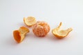 Ripe mandarin with leaves close-up on a white background.