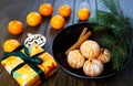 Ripe mandarine with leaves, tangerine mandarine orange in black bowl on wooden table background. Citrus fruits Mandarins in plate. Royalty Free Stock Photo