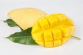 Ripe mango with green leaf of mango on white background, cut in cubes Royalty Free Stock Photo