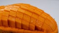 Macro Mango slice cut to cubes close-up isolated on light grey background Royalty Free Stock Photo