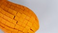 Macro Mango slice cut to cubes close-up isolated on light grey background Royalty Free Stock Photo