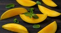Ripe Mango Slices with Fresh Mint on Dark Wooden Background Royalty Free Stock Photo