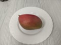 Ripe mango on the white plate Royalty Free Stock Photo