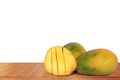 Ripe mangoes on a wooden table with a white background Royalty Free Stock Photo