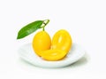 Ripe marian plum cut on plate isolate white background Royalty Free Stock Photo