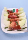 Ripe melon slice with ham, parmesan and Italy flag Royalty Free Stock Photo