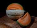 Ripe melon and slice of melon on a wooden board Royalty Free Stock Photo