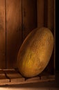 Ripe melon in a wooden box. Photo of a melon in a low key Royalty Free Stock Photo