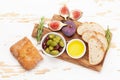 Ripe olives, figs, olive oil and ciabatta bread Royalty Free Stock Photo