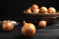 Ripe onions on black wooden table