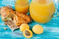 Apricot juice and croissant with golden crust