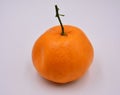 A ripe orange with long fruit pedicel on white background