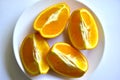Ripe orange sliced on a white plate Royalty Free Stock Photo
