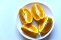 Ripe orange sliced on a white plate Royalty Free Stock Photo
