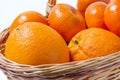 Ripe oranges and mandarines in basket