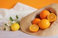 Ripe oranges in a summer hat. Citrus harvest in a hat Royalty Free Stock Photo